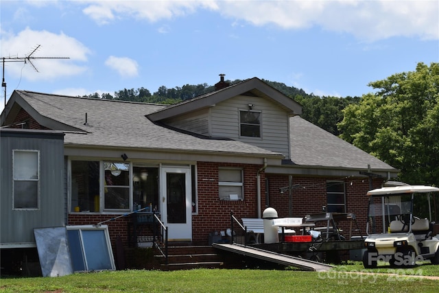 rear view of house with a yard