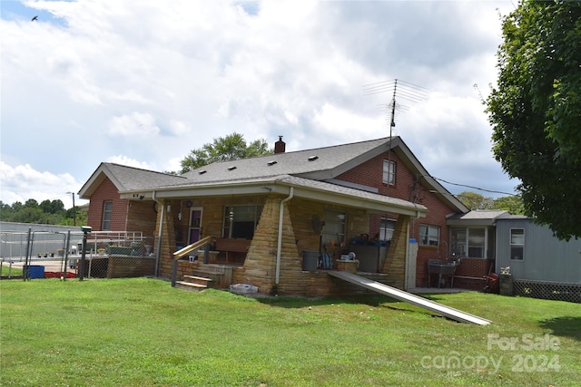 rear view of property with a lawn