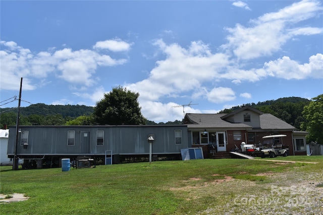 back of house featuring a yard