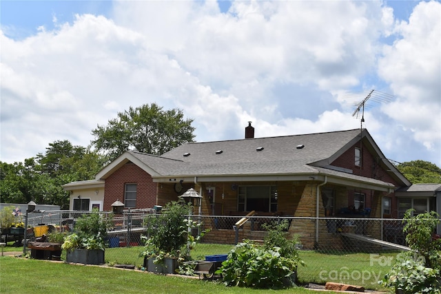 rear view of property with a porch and a lawn