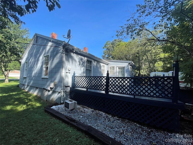 view of home's exterior with central air condition unit and a lawn