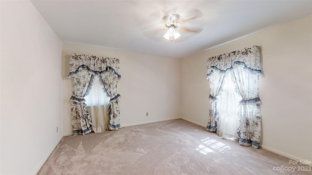 unfurnished room with light carpet and ceiling fan