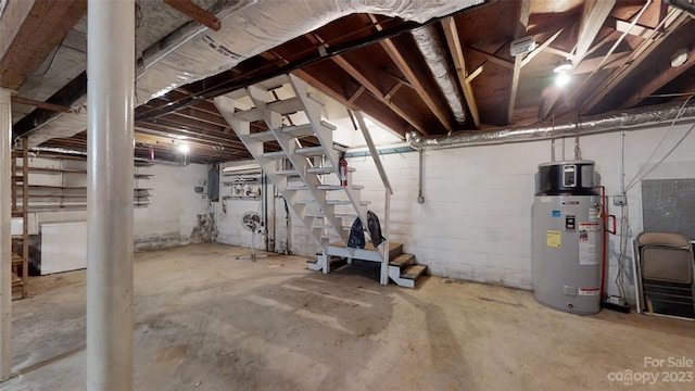 basement featuring water heater and washer / dryer