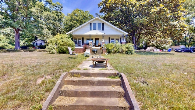 bungalow-style home featuring a porch and a front yard