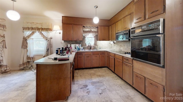 kitchen with pendant lighting, light tile floors, black appliances, and a healthy amount of sunlight