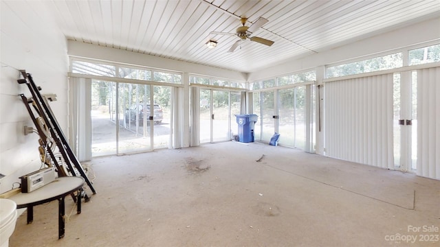 unfurnished sunroom with ceiling fan