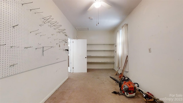 interior space with light carpet and ceiling fan