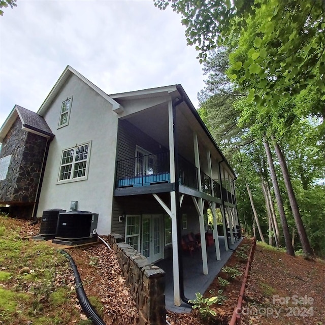 view of property exterior featuring cooling unit and a patio area