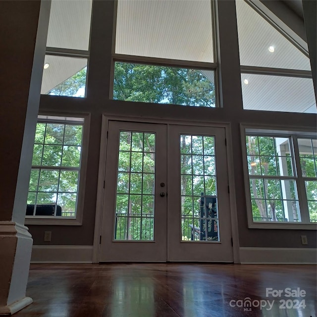 entryway featuring french doors, dark hardwood / wood-style floors, and a high ceiling