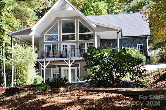 back of property with a balcony