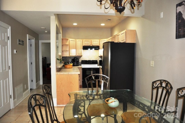 3645 Lake Bluff Dr, Sherrills Ford, NC 28763 - kitchen with under cabinet range hood, electric range, tile countertops, freestanding refrigerator, and light brown cabinets
