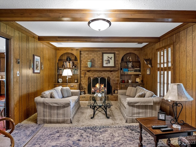 living room with beamed ceiling, carpet flooring, a fireplace, wood walls, and a textured ceiling