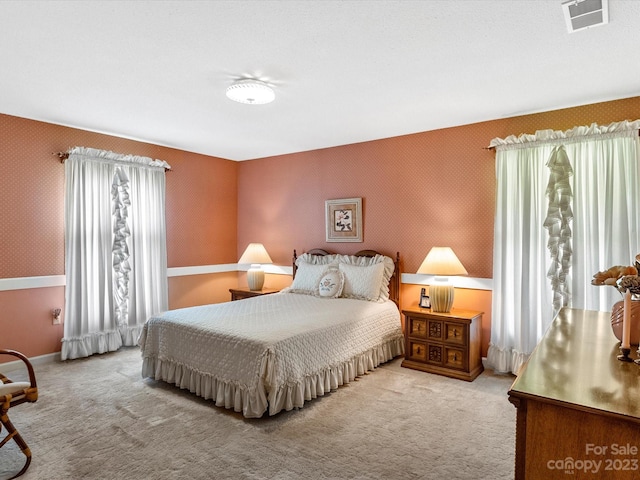 carpeted bedroom with multiple windows