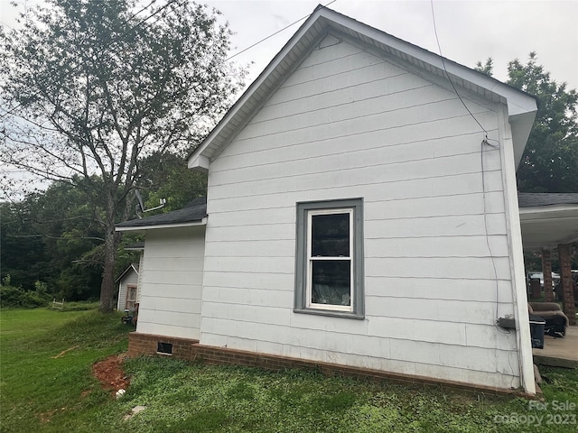 view of side of property with a yard