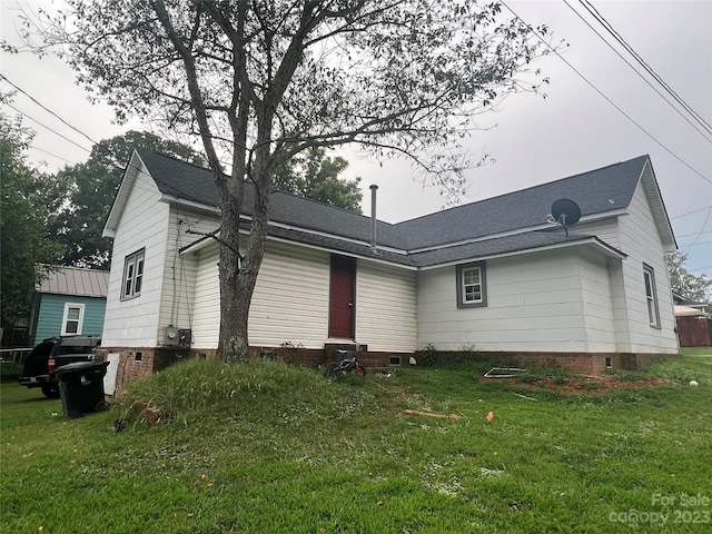 view of side of home with a lawn