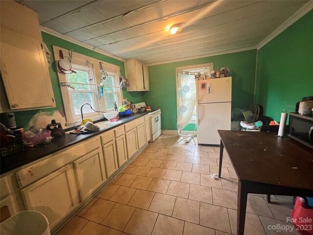 kitchen featuring white appliances, ornamental molding, light tile floors, and sink