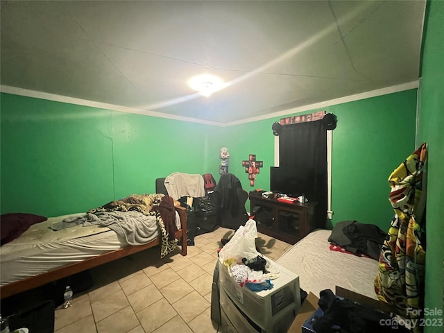 bedroom with light tile flooring and ornamental molding