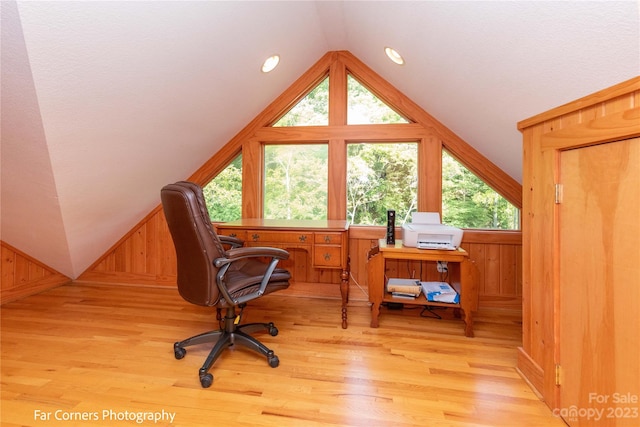 office with light hardwood / wood-style floors and vaulted ceiling