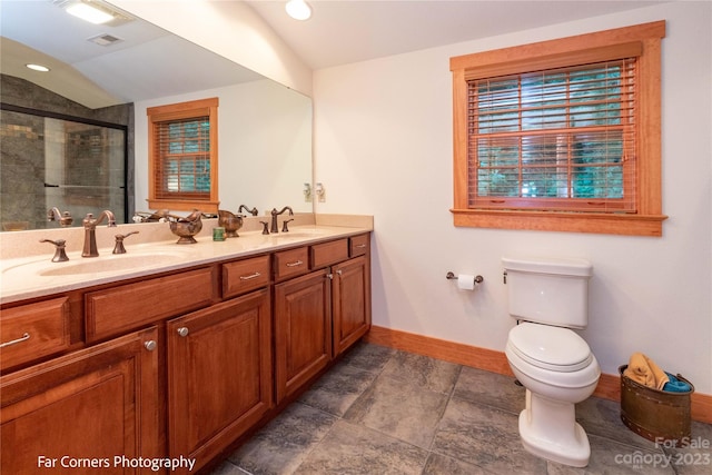 bathroom featuring double sink, lofted ceiling, tile floors, toilet, and oversized vanity