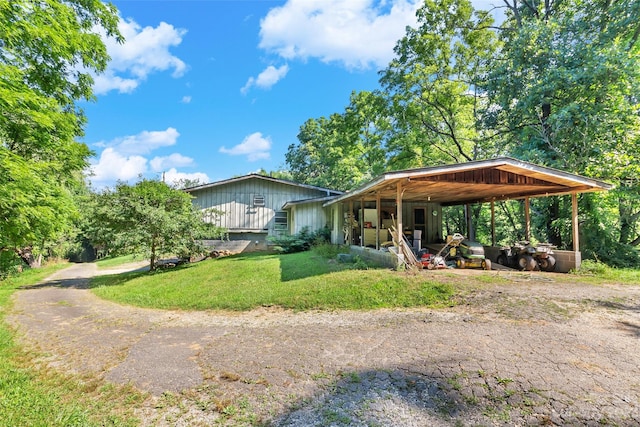 view of front of property with a front lawn and a carport