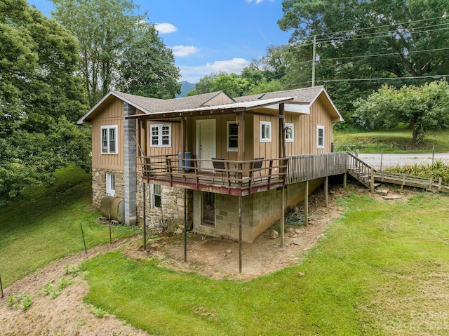 back of house with a yard and a deck