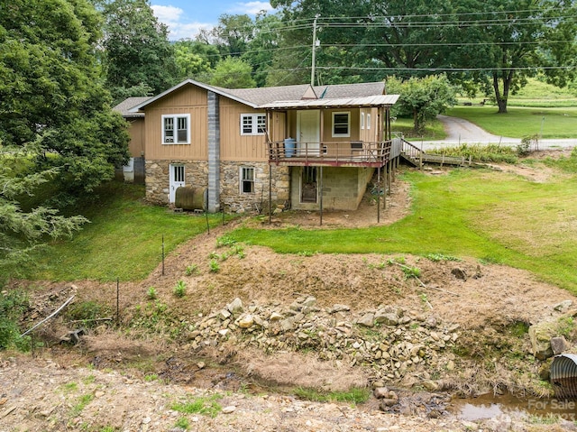 rear view of property featuring a yard