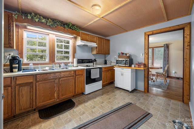 kitchen with sink, white range with gas cooktop, and light tile floors