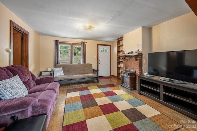 living room featuring a fireplace and light wood-type flooring