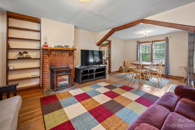 living room with dark hardwood / wood-style floors and a brick fireplace