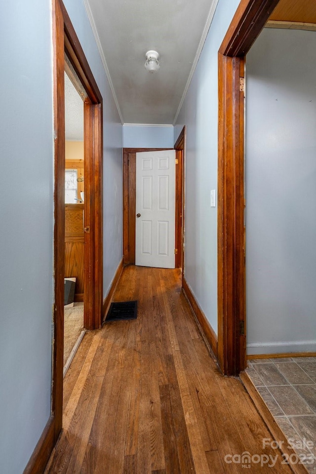 hall with crown molding and dark hardwood / wood-style floors