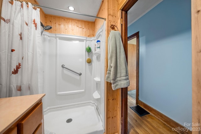 bathroom with curtained shower, hardwood / wood-style floors, and vanity