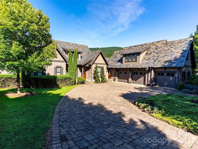 view of front of home with a front lawn and a garage