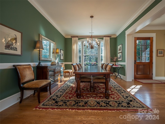 dining room featuring crown molding, a chandelier, and light wood-type flooring