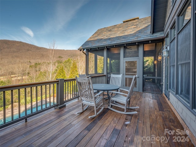 deck with a swimming pool and a mountain view