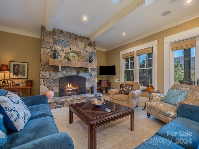 carpeted living room featuring crown molding, beam ceiling, and a stone fireplace