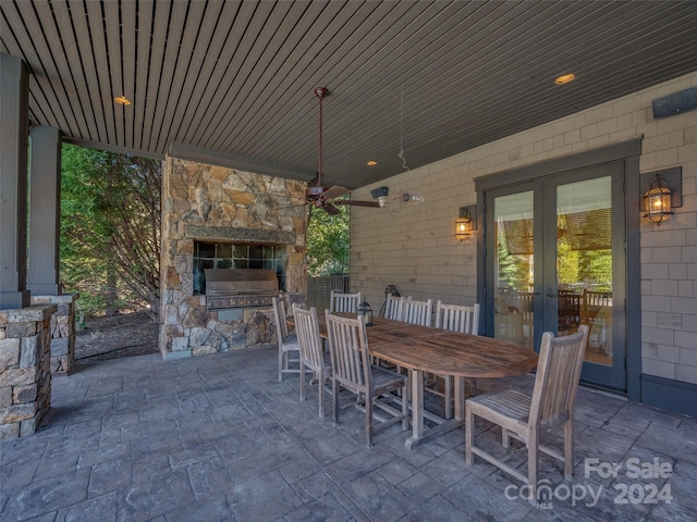 view of patio / terrace featuring an outdoor stone fireplace and french doors