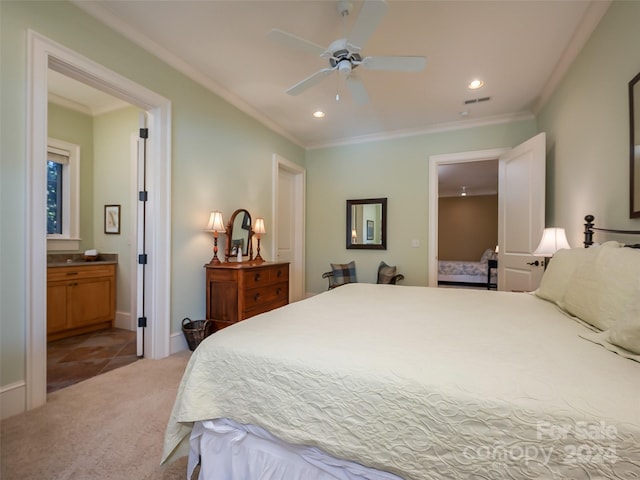 carpeted bedroom featuring ceiling fan, ensuite bath, and ornamental molding