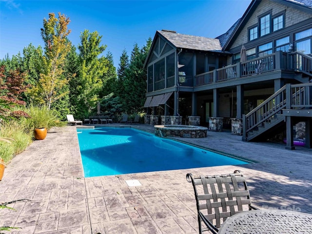 view of swimming pool featuring an in ground hot tub and a patio