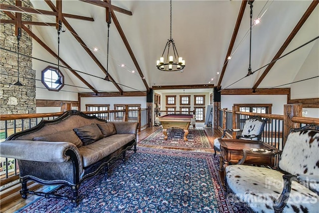 living area with high vaulted ceiling, a notable chandelier, pool table, and dark hardwood / wood-style flooring