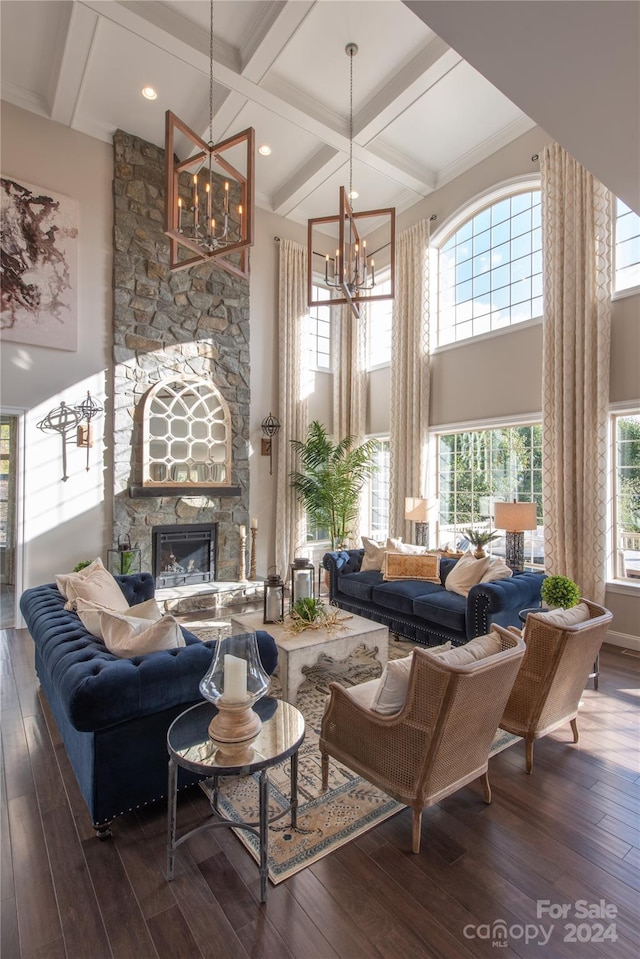 living room with hardwood / wood-style floors, a towering ceiling, a fireplace, and coffered ceiling