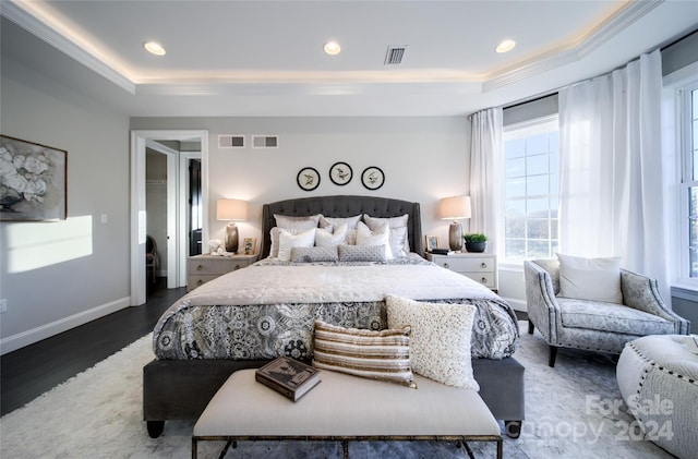 bedroom featuring visible vents and a raised ceiling