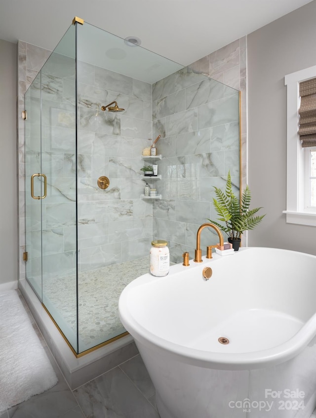 full bathroom featuring a freestanding bath and a stall shower