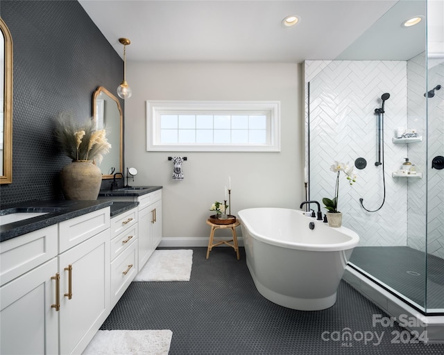 bathroom featuring a sink, recessed lighting, double vanity, tiled shower, and a freestanding bath