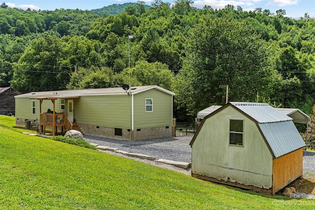 exterior space featuring a storage shed and a yard