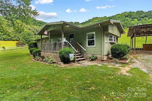 rear view of property with a porch and a lawn