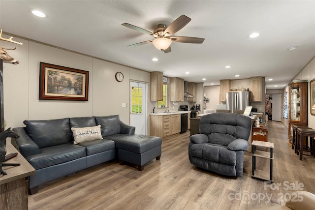 living room with wood-type flooring and ceiling fan