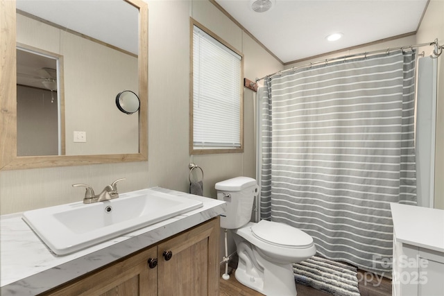 bathroom featuring crown molding, vanity, toilet, and a shower with shower curtain