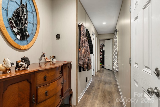 hallway with hardwood / wood-style flooring