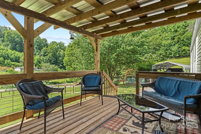 wooden deck with an outdoor living space and a lawn