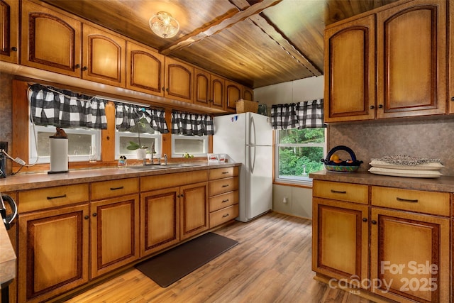 kitchen with sink, backsplash, white refrigerator, wooden ceiling, and light wood-type flooring